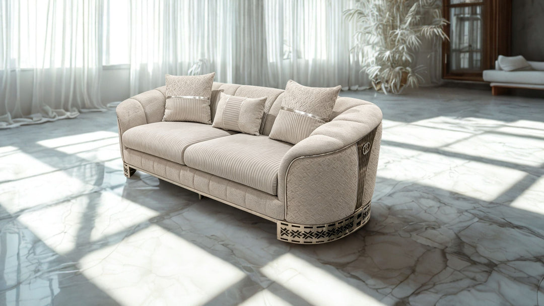 Luxury cream upholstered sofa with decorative pillows in a bright marble living room.