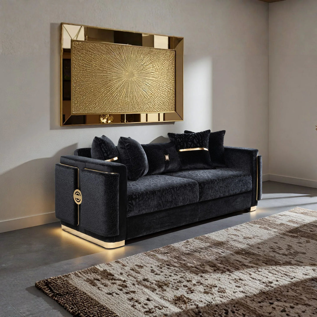 Luxury black velvet sofa with gold accents in a modern living room setting.