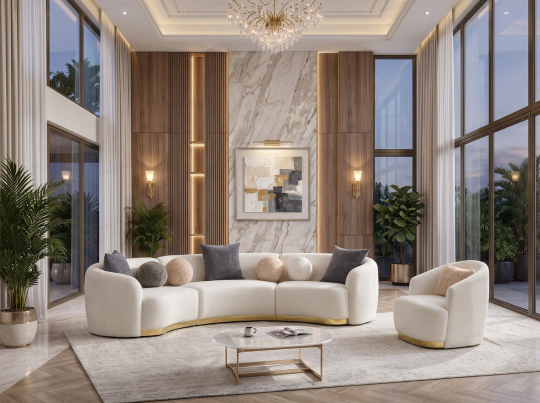 Cleo ivory and gold grand curved sofa with rounded arms and a coordinating armchair, shown in a styled living room